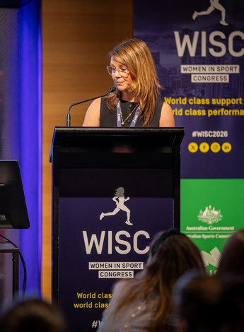 The image is of Jodie Dakic presenting at the Women in Sport Congress